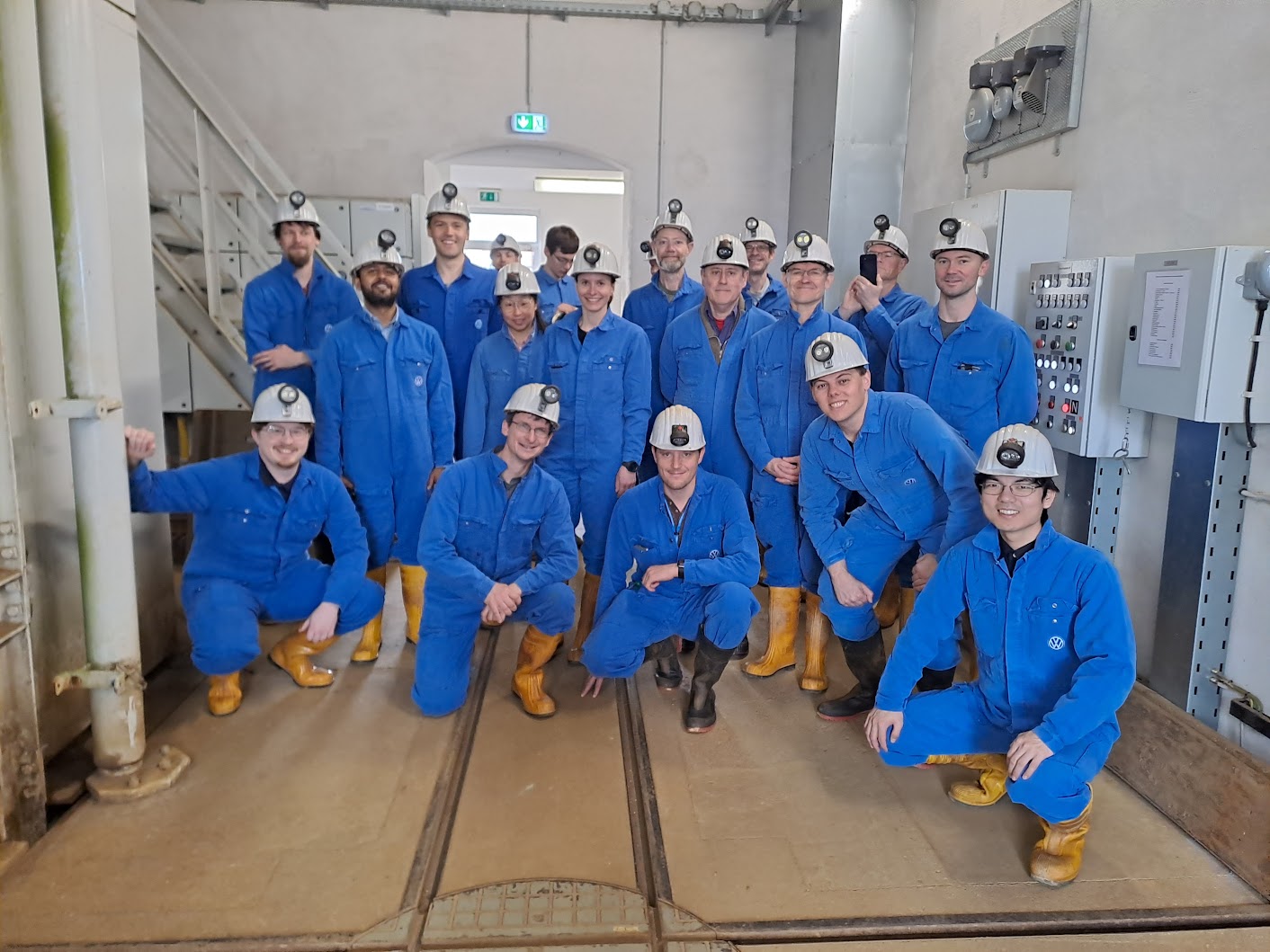 Participants of the 2026 workshop in miners' overalls before the excursion into the silver mine