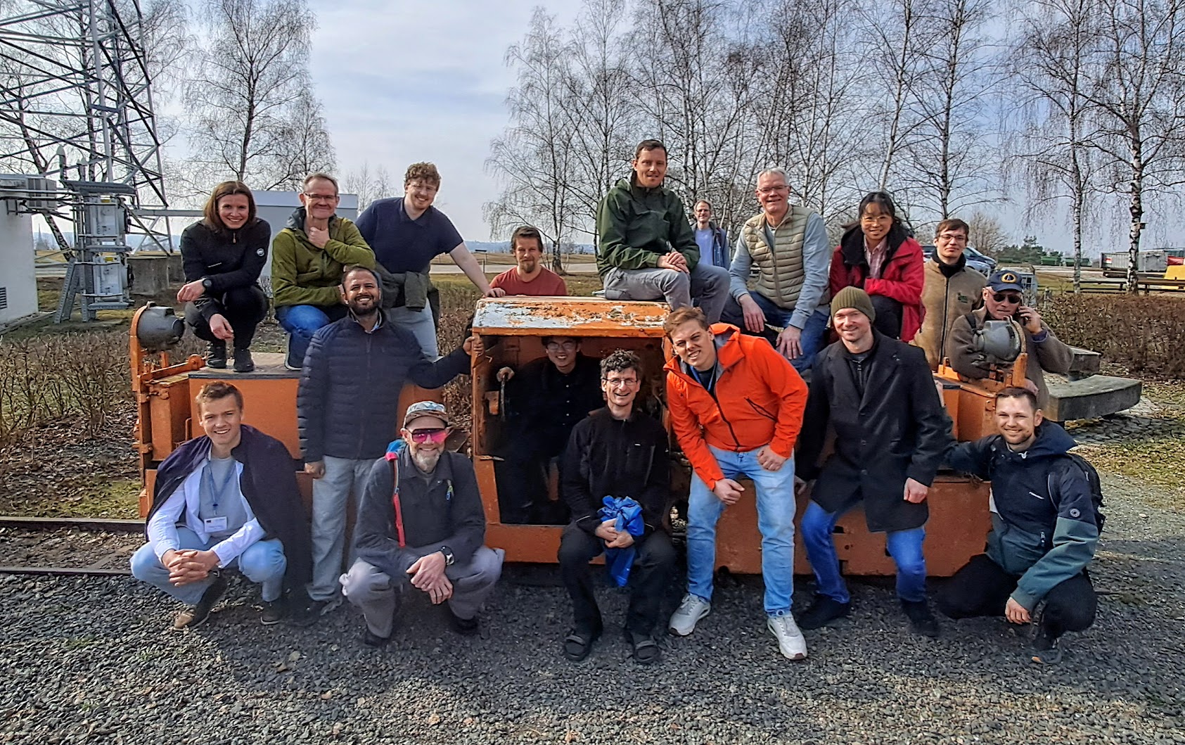Participants of the 2026 workshop around a mine cart in Freiberg
